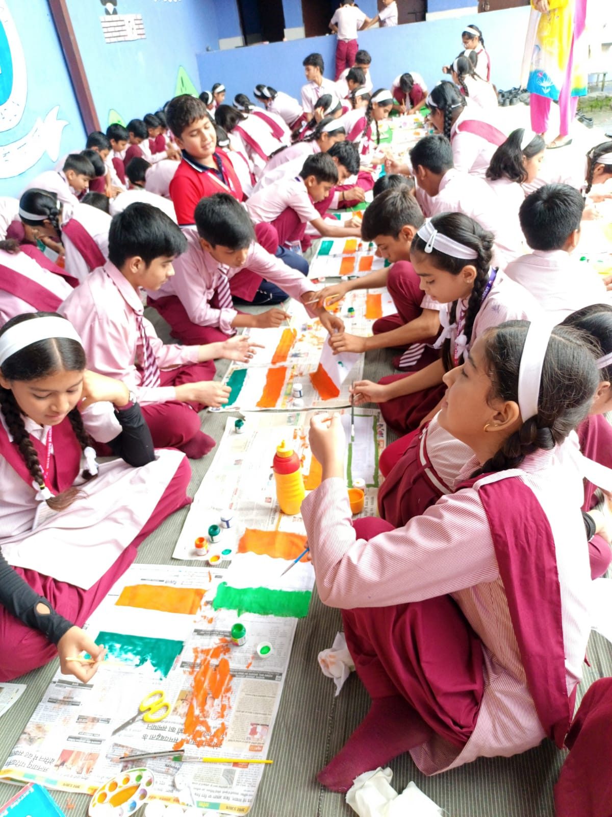 Students painting Indian flags during an education activity